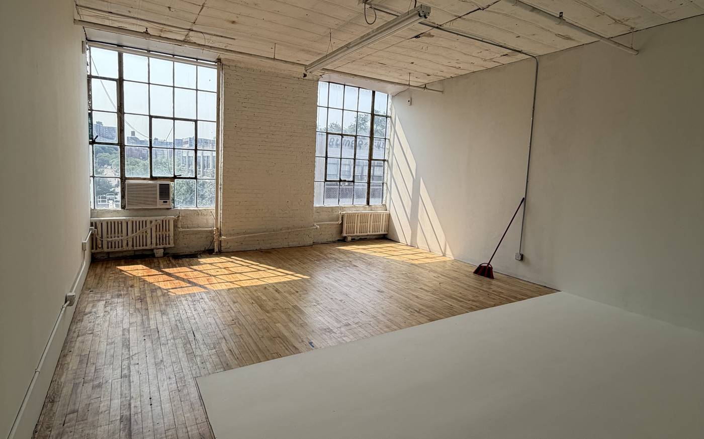 YITUO Studio: daylight studio with white cyc wall and hardwood floor